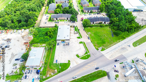 Aerial view of a commercial building and residential apartment complex in a suburban area