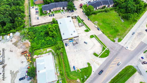 Aerial view of a commercial retail building and parking lot in a suburban area