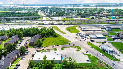 Aerial view of a residential and commercial area near a large highway bridge