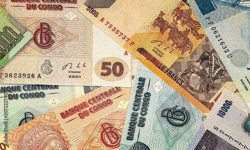 фотографія Congolese franc money bills in pile on table