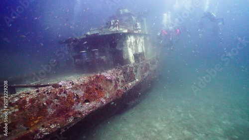 Wide View of Sunken Tugboat Shipwreck from the Stern with Scuba Divers Ahead
