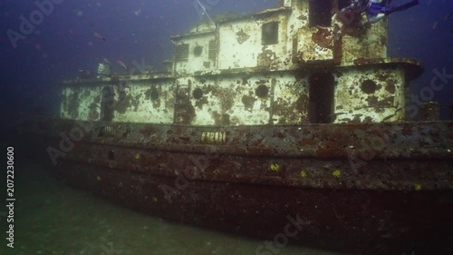 Wide Angle Shot of a Sunken Tugboat Shipwreck on the Ocean Floor