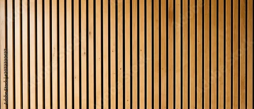 Obraz  z motywem Minimalist background of vertical light wood slats forming a linear pattern