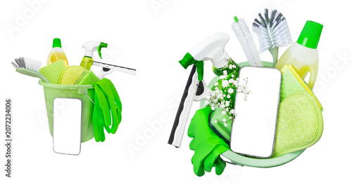 Isolated bucket or basket with cleaning items, white flowers and smartphone with empty display. Spring cleaning concept. Housecleaning, hygiene, spring, chores, cleaning supplies. Copy space, mockup.