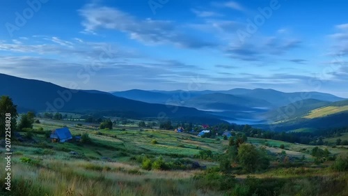 Panoramic view of rolling hills under a vibrant blue sky with soft sunlight