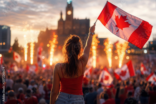 Vibrant Canada Day celebrations in city square with cheerful crowd waving flags under fireworks