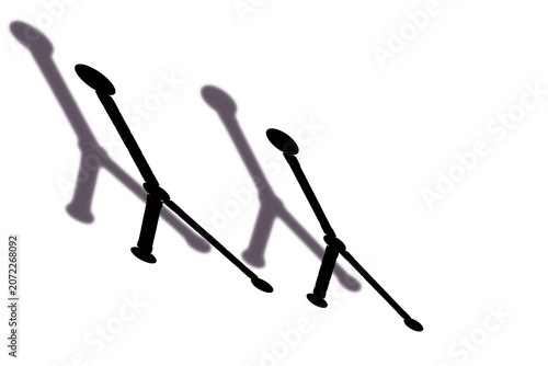 Two distinct black stylized microphones casting lengthy shadows, isolated with a transparent background