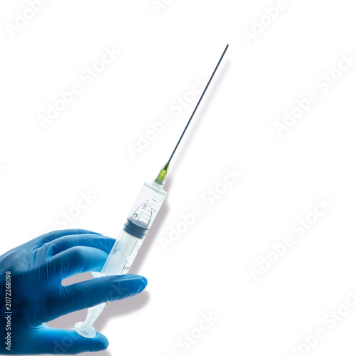 Doctor hand in blue glove holding a medical syringe with an extra long needle