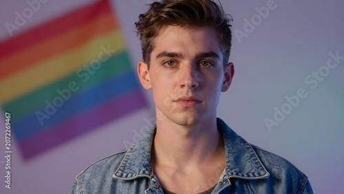 Young Handsome White Man Portrait with LGBTQ Pride Flag Background