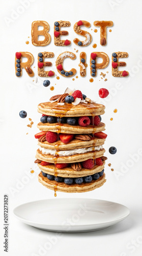 Levitating multi layered Pancakes and BEST RECIPE text made of organic ingredients above a plate, conceptual food photography on white background