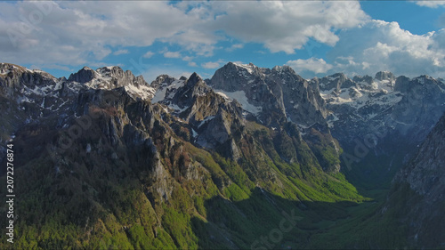 Rocky snow mountains before sunset aerial