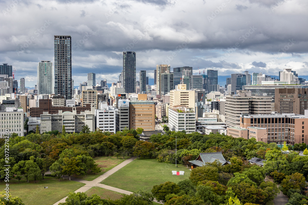 Obraz premium Viewing business district with contemporary architecture and layered cityscape in daylight, Osaka, Japan