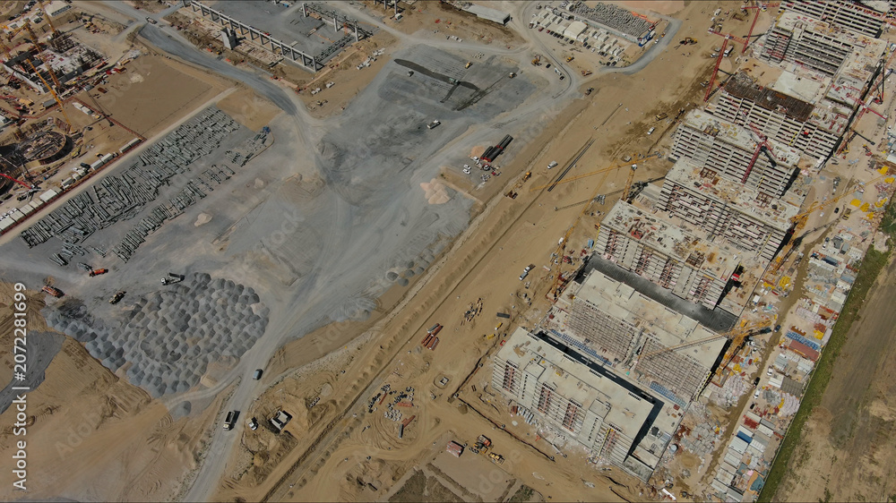 Fototapeta premium Industrial construction site with construction equipment and materials