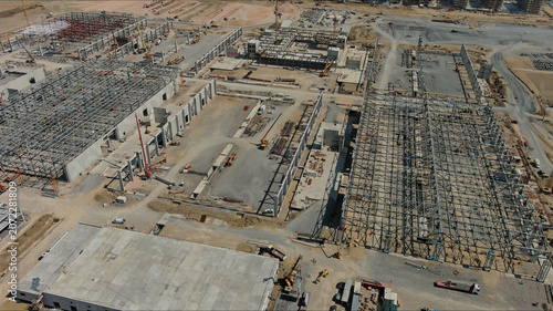 Industrial construction site with construction equipment and materials
