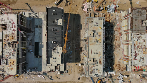 Industrial construction site with houses equipment and materials
