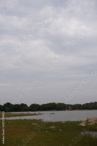 Vertical view of reservoir shoreline and cloudy sky
