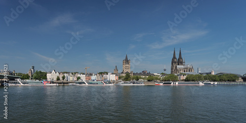 Photos Wide panoramic view of Cologne's historic waterfront on the Rhine River with the Cathedral, old town, and cruise ships