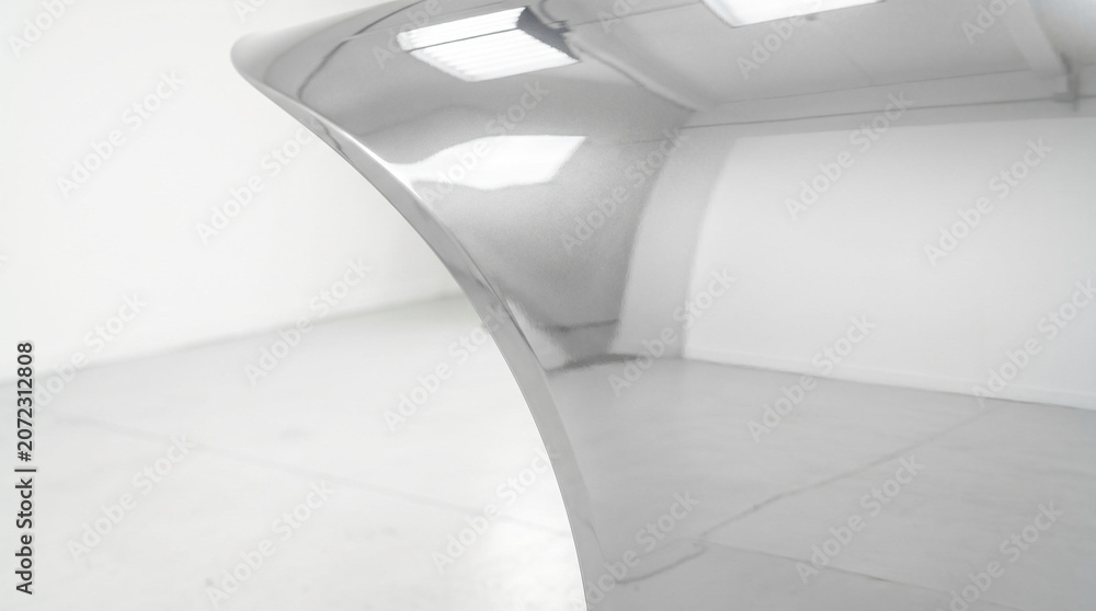 Fototapeta premium Modern abstract polished metal sculpture in minimalist white gallery space