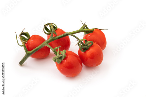 Fresh tomatoes on a vine ready for cooking and serving in a kitchen setting