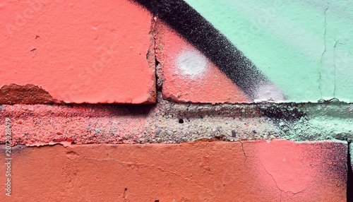 Colorful abstract painted brick wall with weathered texture