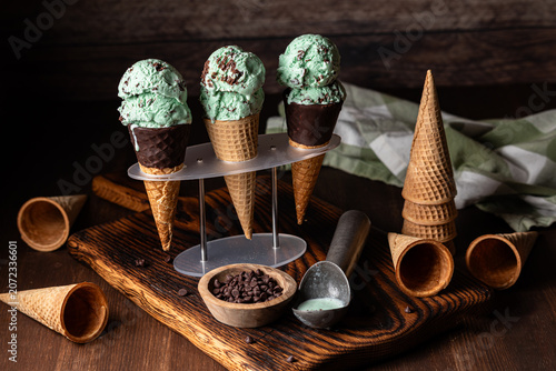 Mint chocolate chip ice cream cones against a dark background.