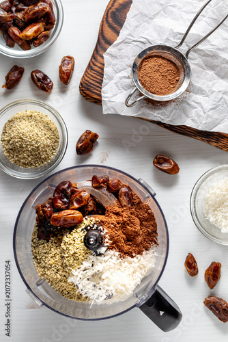A food processor filled with ingredients for making energy balls.