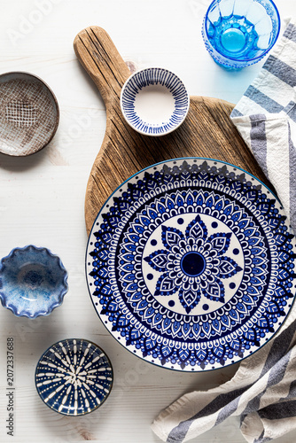 A set up of dishes displayed in a mediterranean theme for food photography.