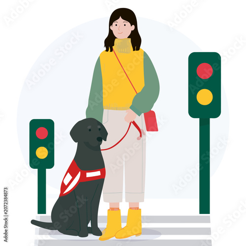 Woman with assistance dog waiting at traffic light