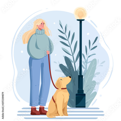 Woman with assistance dog waiting outdoors beside lamppost