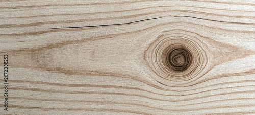 Photos A close-up photo of natural wood grain featuring a distinctive knot texture