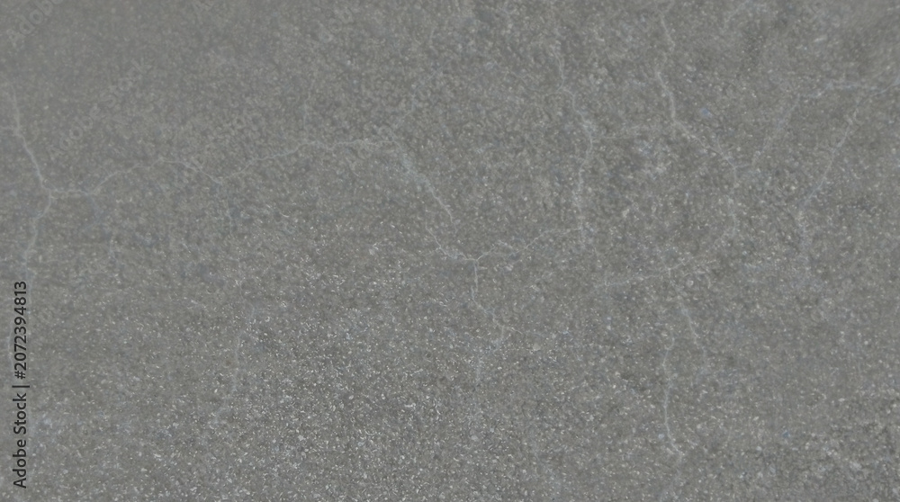 Fototapeta premium Industrial gray concrete texture with subtle cracks, weathered cement wall background, minimalist stone surface for architectural design and overlays