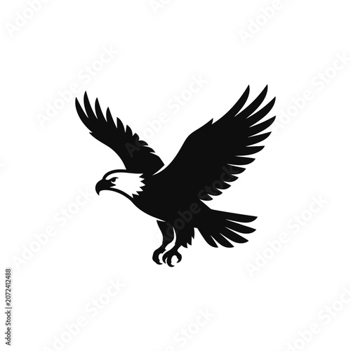 Black silhouette of an eagle in flight with wings spread wide