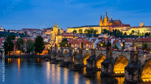 Night View of Historic Stone Bridge and Majestic Castle Over River in Beautiful City Skyline
