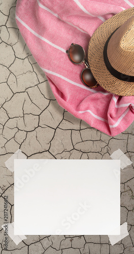 Summer Holiday Vacation Trip Mockup Concept Wallpaper with White Blank Free Space Paper Sheet with Adhesive Tape on Ground Soil Surface. File with Clipping Path.
