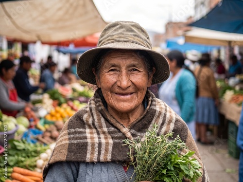 Portrait of a smiling elderly indigenous woman holding fresh herbs in an outdoor market