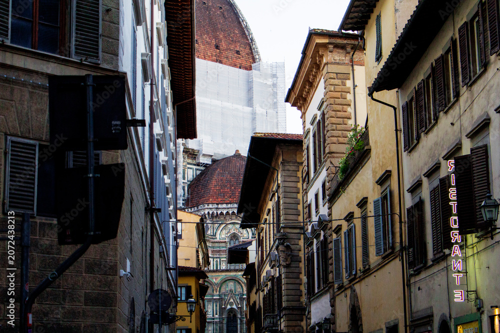 Fototapeta premium The Duomo of the Cattedrale di Santa Maria del Fiore Seen From a Narrow Street, Florence, Italy