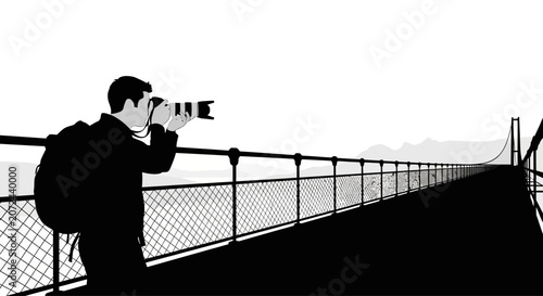A silhouette of a photographer capturing images while standing on a bridge.