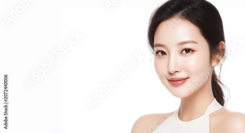 Model poses for a beauty shoot in a studio during the daytime, showcasing natural makeup and simple design