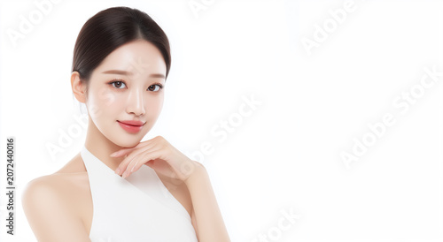 Woman poses with hand on chin against white background in studio setting during daytime