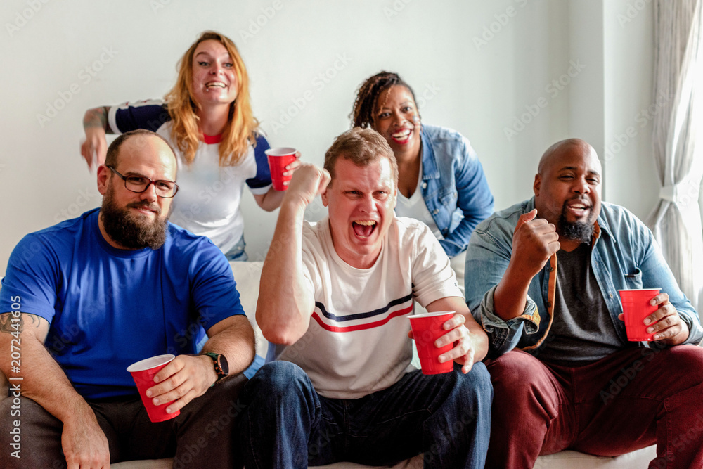 Fototapeta premium Friends celebrating with red cups