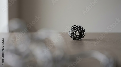 Small decorative metal ball on table.