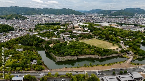 Canvas-taulu Aerial View of Himeji Castle, Moat and Historic Fortifications Surrounded by Cit