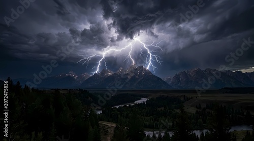 Time lapse storm clouds over mountain landscape with dramatic sky, shifting light, fog and sunset over nature, forest, distant city and sea under dark blue cloudy weather