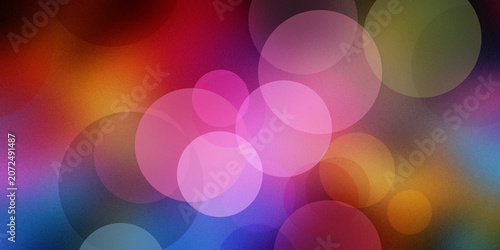 Фотография Colorful bokeh circles overlaying dark background with glowing soft light orbs in shades of pink orange blue purple and warm yellow