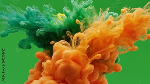 Orange and dark blue ink clouds swirl on green background