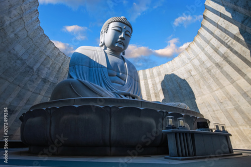 Sapporo, Japan - October 30 2025: Makomanai Takino Cemetery is a vast greenspace features a collection of 40 Moai head, a Stonehenge replica and a giant Buddha statue.