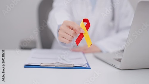 World hepatitis day awareness month, 28 July. Doctor give Red and Yellow ribbon for Liver cancer, Jaundice, Cirrhosis, Failure, Enlarged, Hepatic Encephalopathy and Health concept