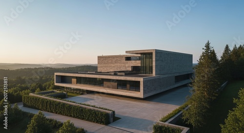 Aerail Full Perspective View of a Modern Minimalist Concrete Mansion Nestled Within Forrest Terrain