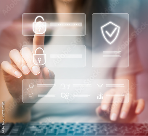 A woman clicks on a hologram on a computer touch screen, symbolizing secure access, digital trust, access control, and data privacy
