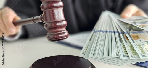 Obraz na plátně Judge presiding over a courtroom with cash bundles and gavel during a legal proc